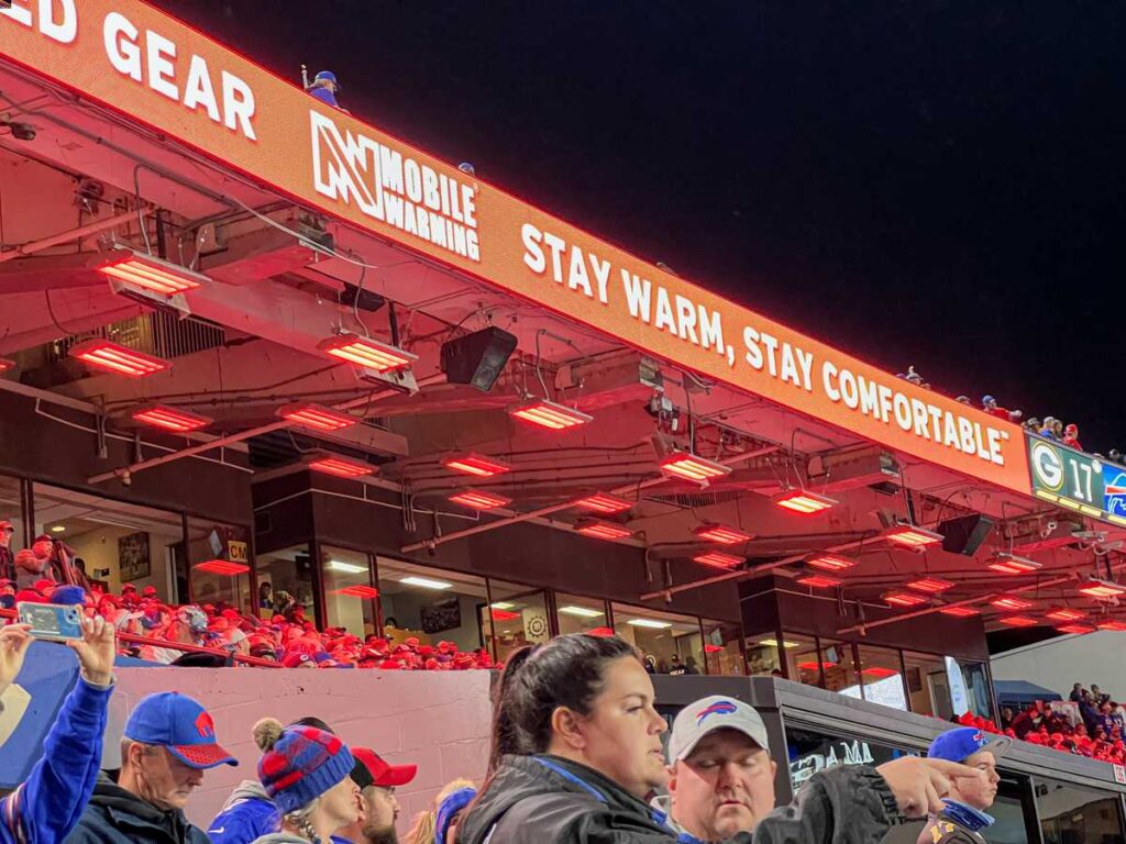 Bills fans in the Club Level sideline seats stay warm with radiant heaters overhead