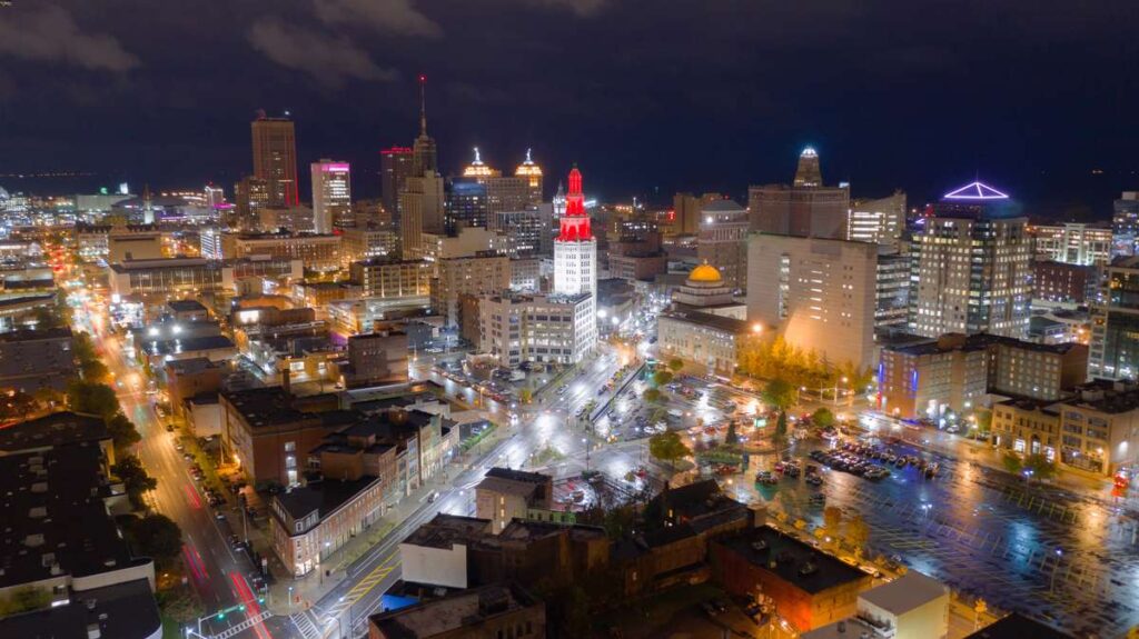 the buildings of downtown Buffalo are lit up at night