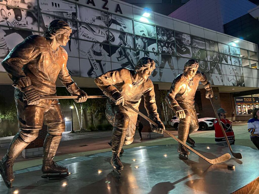 a statue of the French Connection (Gilbert Perrault, Rick Martin and Renè Robert) outside the Buffalo Sabres arena