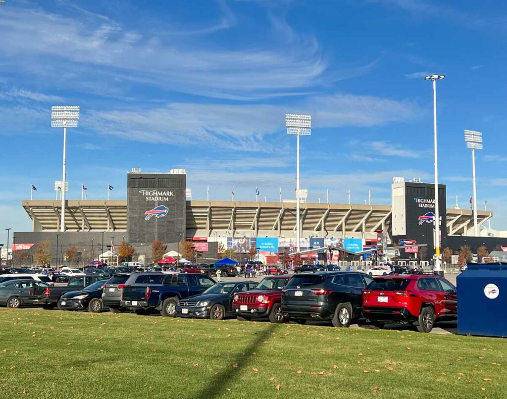cars in a parking lot at Highmark Stadium before a primetime game 