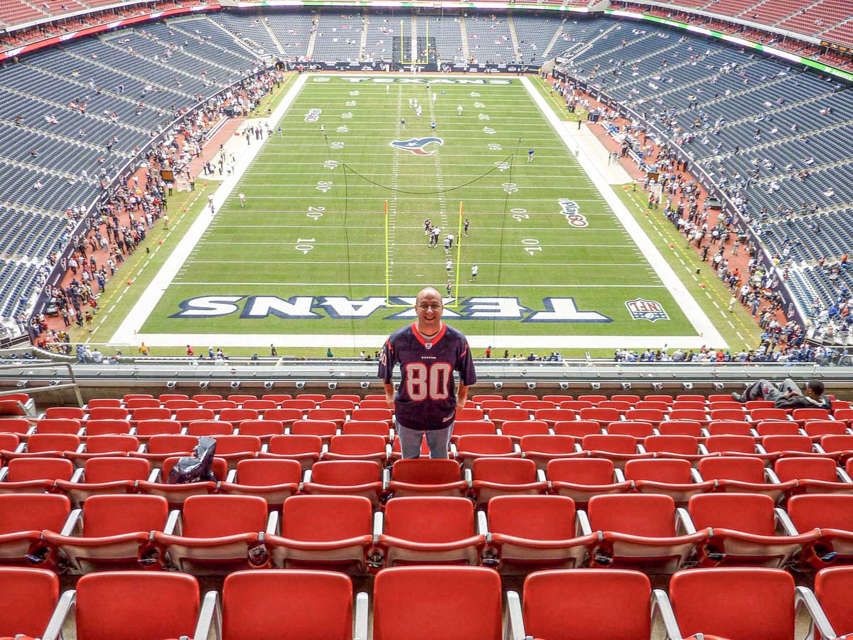Dan Brewer poses for a picture in the upper deck end zone seats at NRG Stadium before a Houston Texans game.