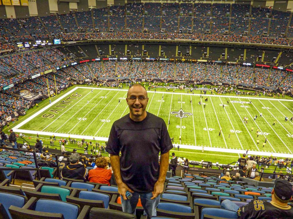 Dan Brewer, ownder of UltimateSportsRoadTrip.com, stands at his seat for the Saints vs Patriots game on Monday Night Football.