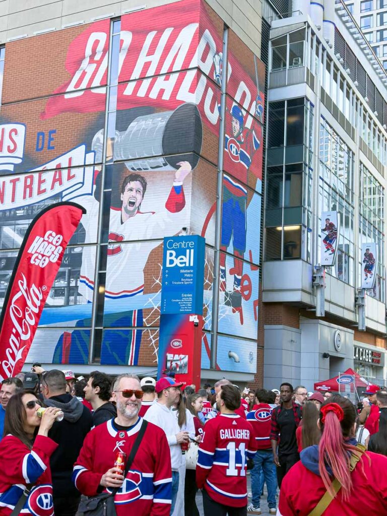 Montreal Canadiens fans gather outside Centre Bell to watch a Canadiens playoff game on a big screen.