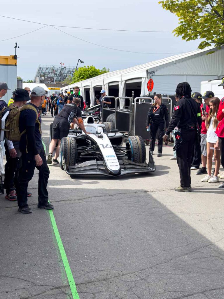 Mechanics for an F2 team work on a car in the F2 Paddocks at the Montreal Grand Prix.
