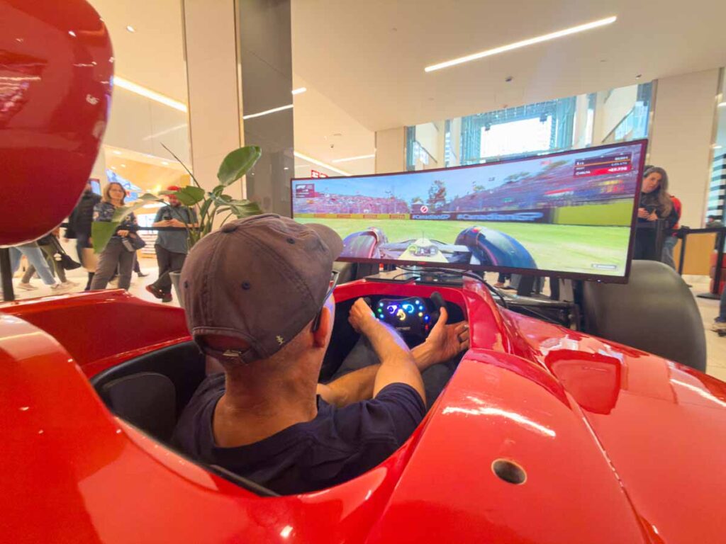 Dan Brewer, owner of Ultimate Sports Road Trip, tries an F1 simulator at the Pit Stop in Eaton Centre.