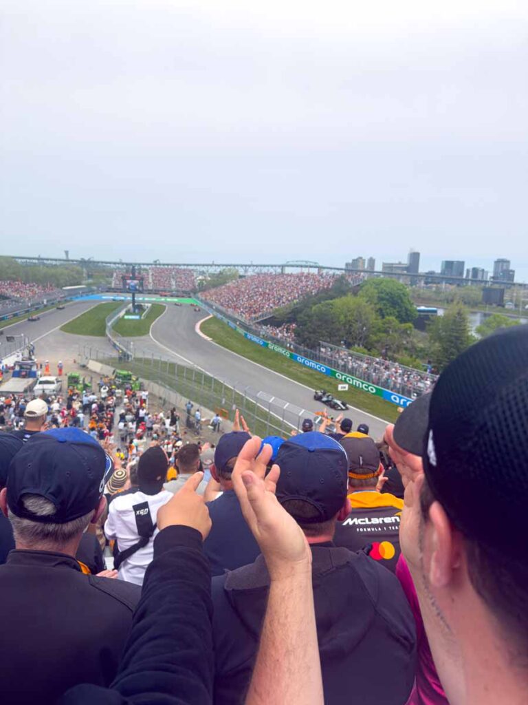 Warmly dressed F1 fans cheer on a rainy day at the Montreal Grand Prix in May.